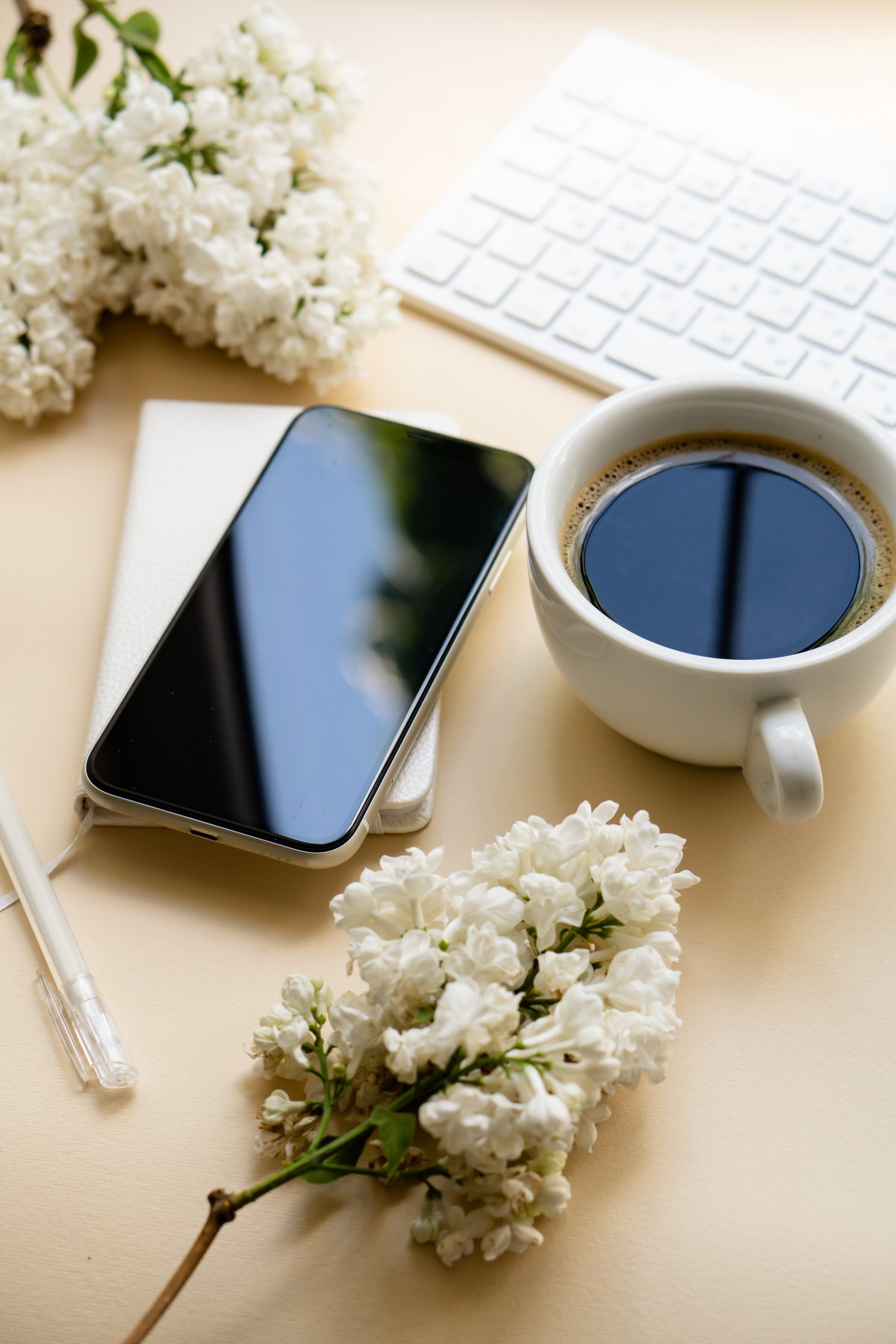 Keyboard with Coffee and Smartphone on Neutral Background